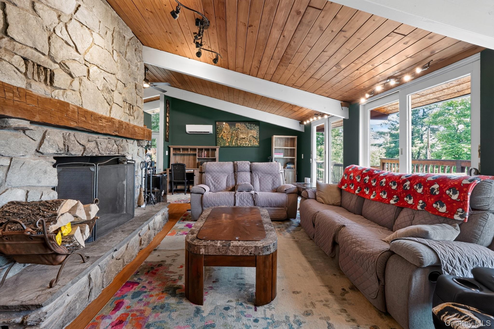 424 Laroe Road Chester, NY 10918 - Photo 35 of 43 Living area featuring a stone fireplace with a wood mantle, vaulted wood-paneled ceiling, recessed lighting, and sliding glass doors