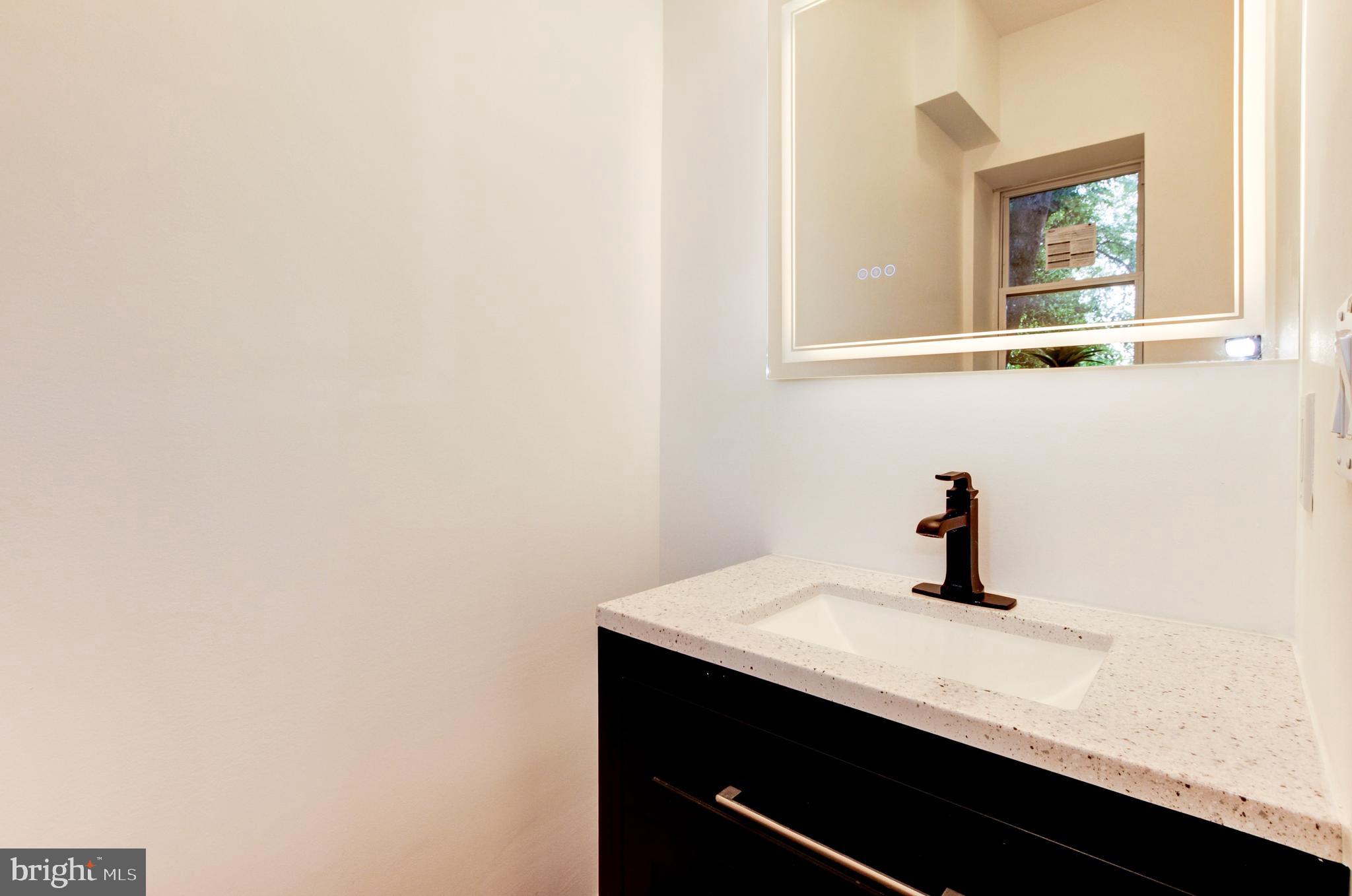 1324 Aisquith Street Baltimore, MD 21202 - Photo 12 of 47 a bathroom with a sink and a mirror