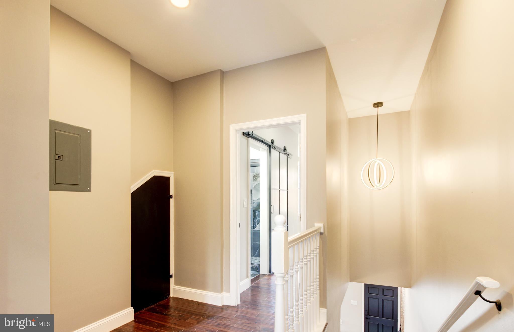 1324 Aisquith Street Baltimore, MD 21202 - Photo 17 of 47 a view of a hallway with wooden floor and staircase