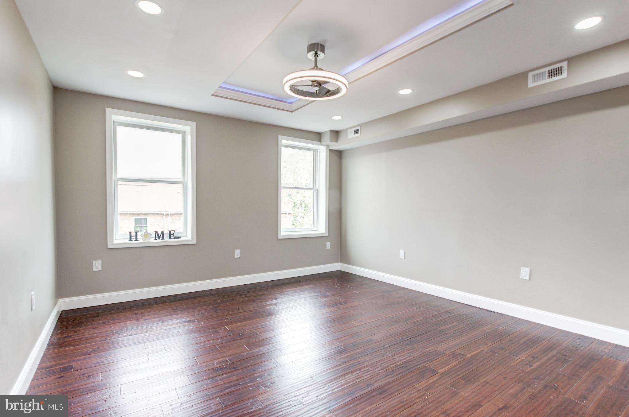 1324 Aisquith Street Baltimore, MD 21202 - Photo 20 of 47 a view of an empty room with wooden floor and a window
