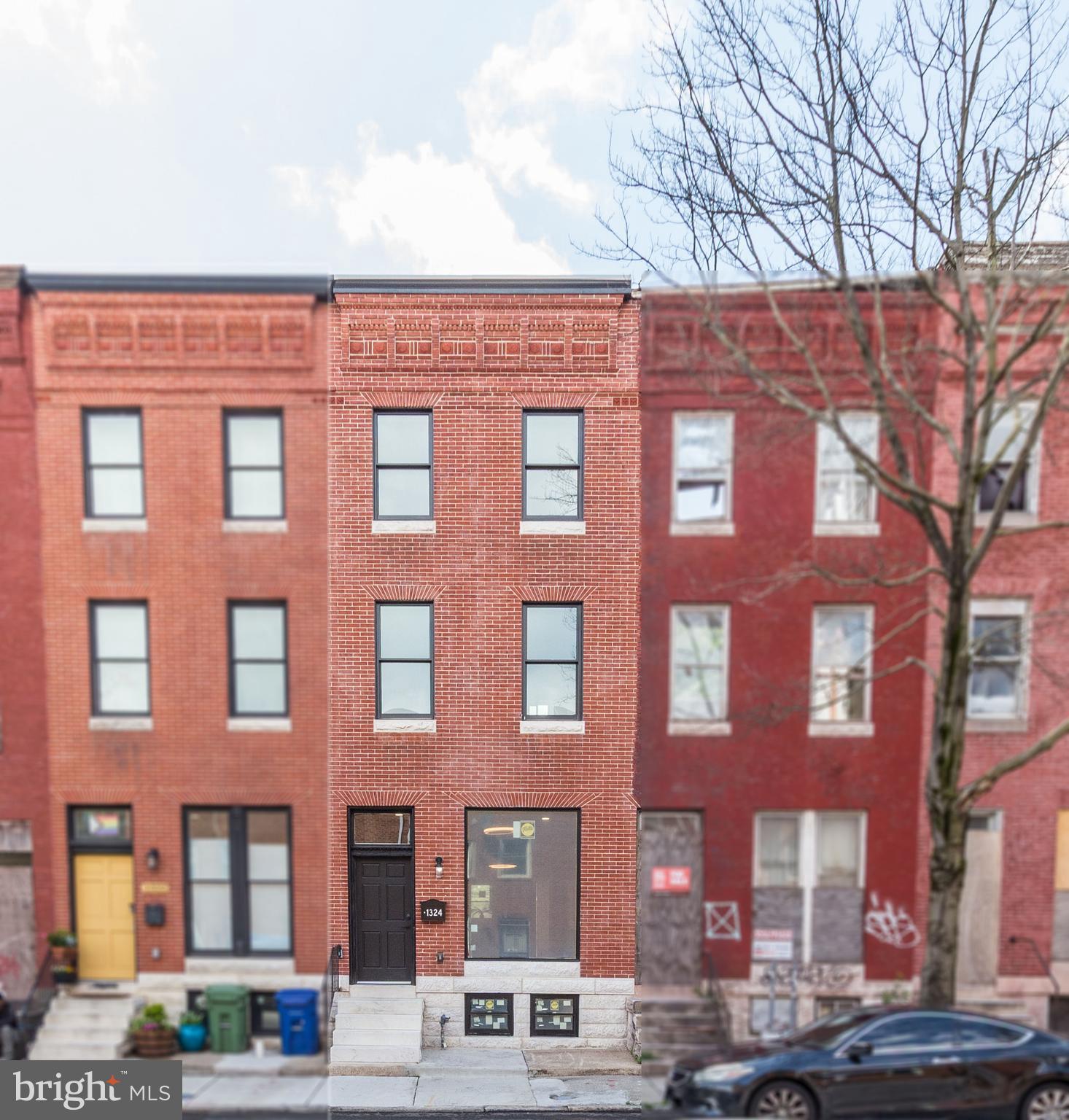 1324 Aisquith Street Baltimore, MD 21202 - Photo 2 of 47 a front view of a building with lot of cars and trees