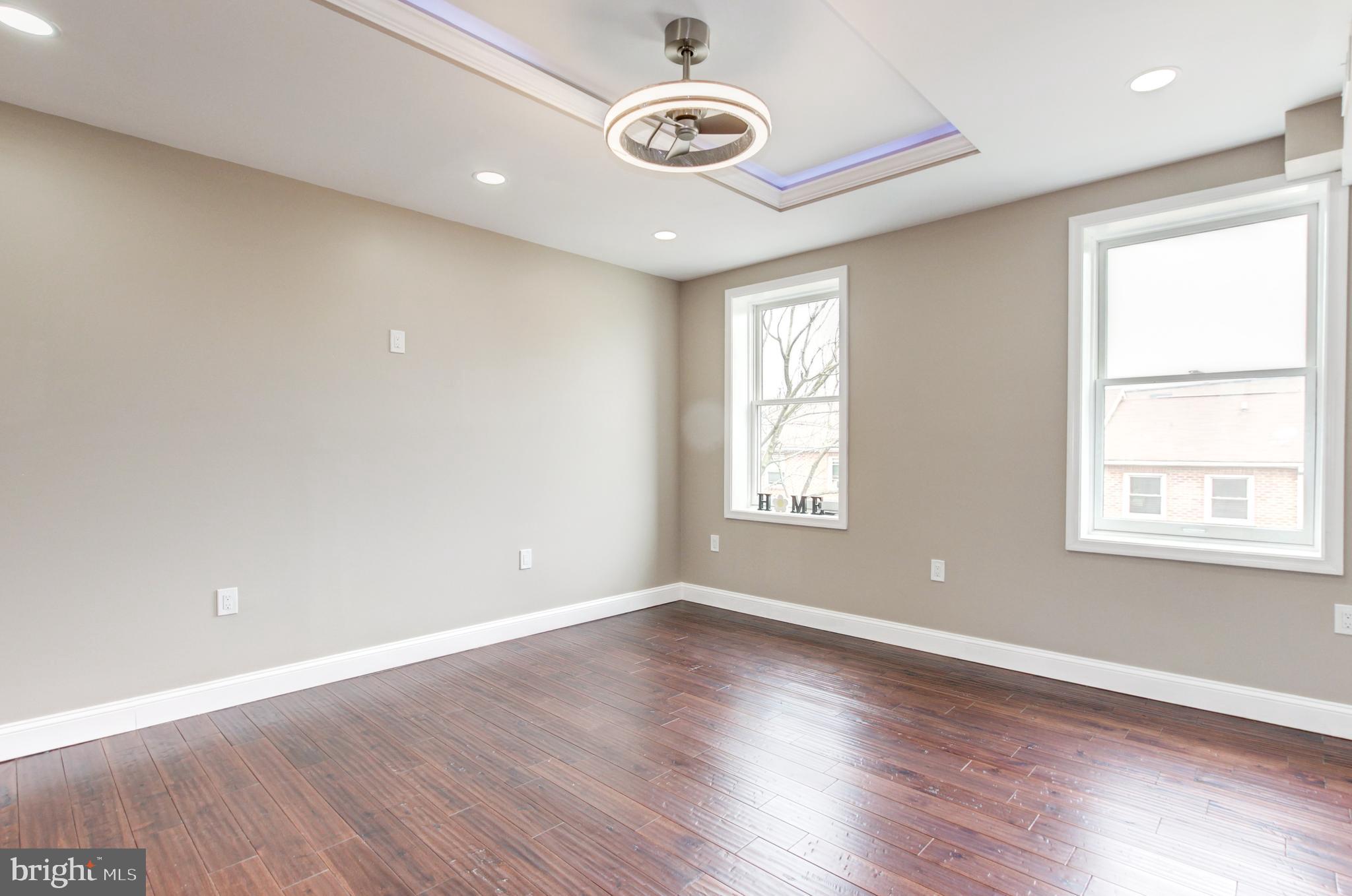 1324 Aisquith Street Baltimore, MD 21202 - Photo 21 of 47 an empty room with wooden floor and windows
