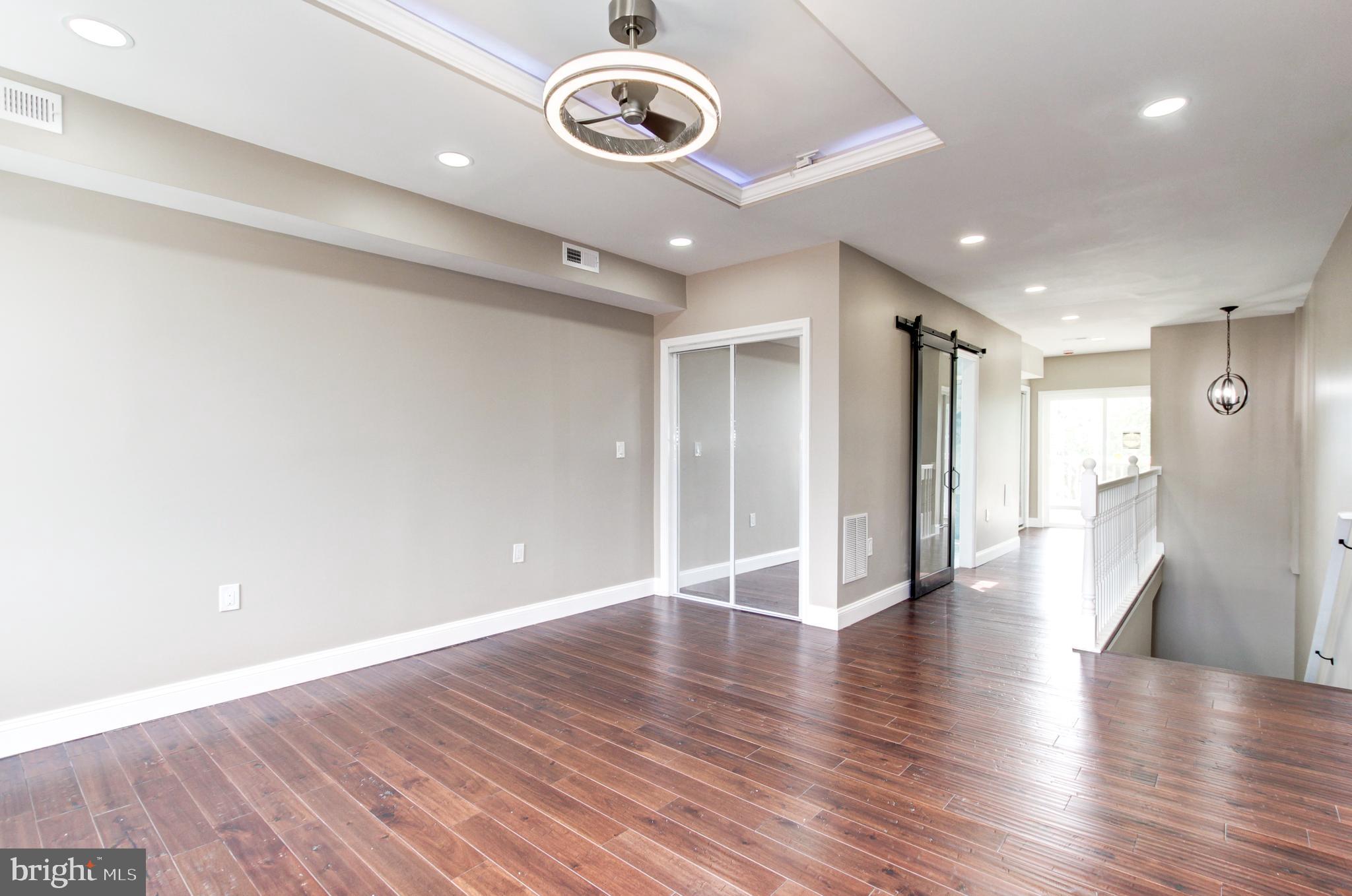 1324 Aisquith Street Baltimore, MD 21202 - Photo 25 of 47 a view of an empty room with wooden floor