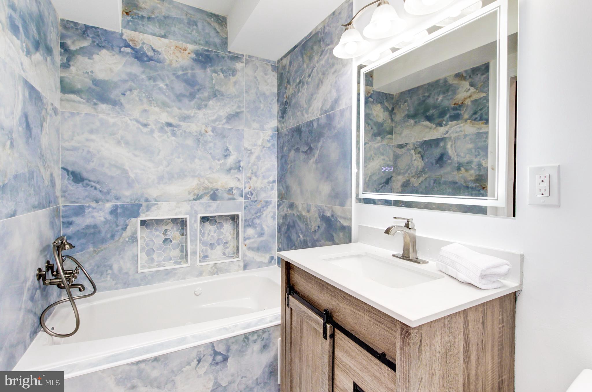 1324 Aisquith Street Baltimore, MD 21202 - Photo 26 of 47 a bathroom with a sink and a bathtub