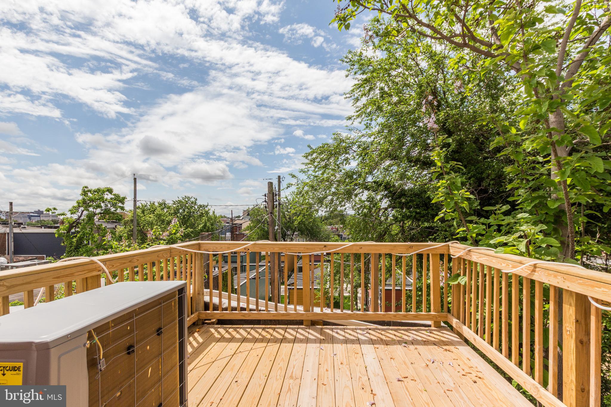 1324 Aisquith Street Baltimore, MD 21202 - Photo 29 of 47 a view of a balcony with wooden floor and fence