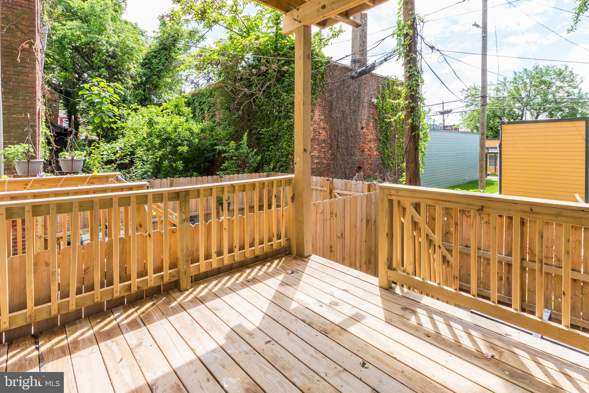 1324 Aisquith Street Baltimore, MD 21202 - Photo 40 of 47 a view of balcony with wooden floor and fence