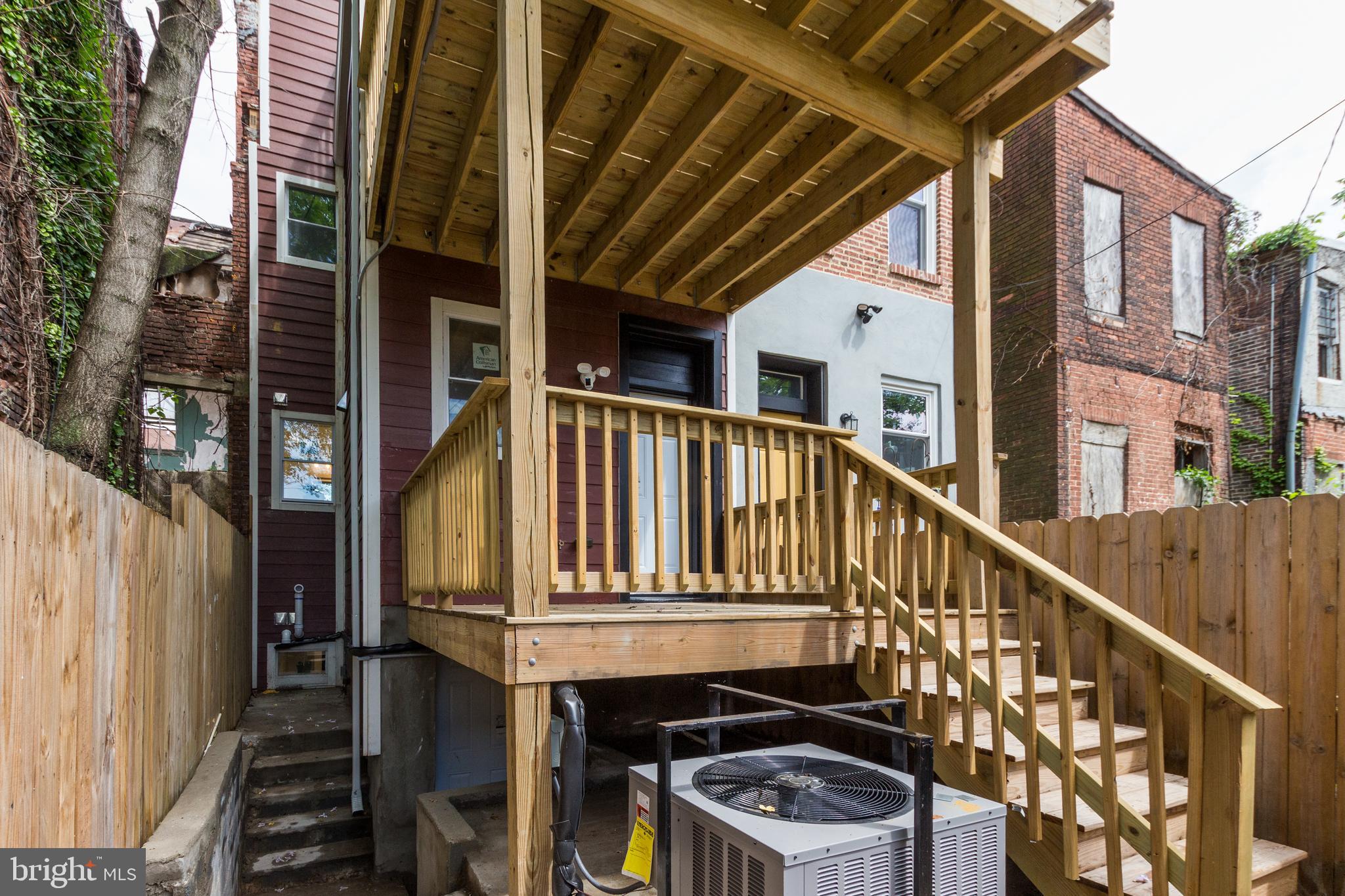 1324 Aisquith Street Baltimore, MD 21202 - Photo 42 of 47 a front view of a house with wooden stairs