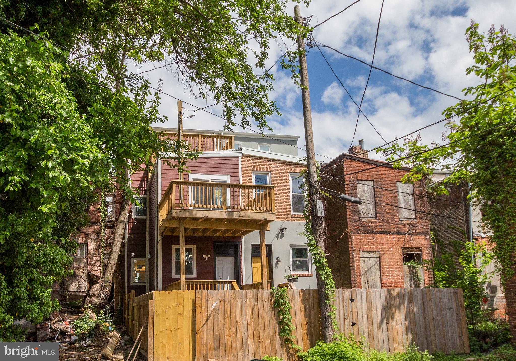 1324 Aisquith Street Baltimore, MD 21202 - Photo 43 of 47 a front view of a building with a garden