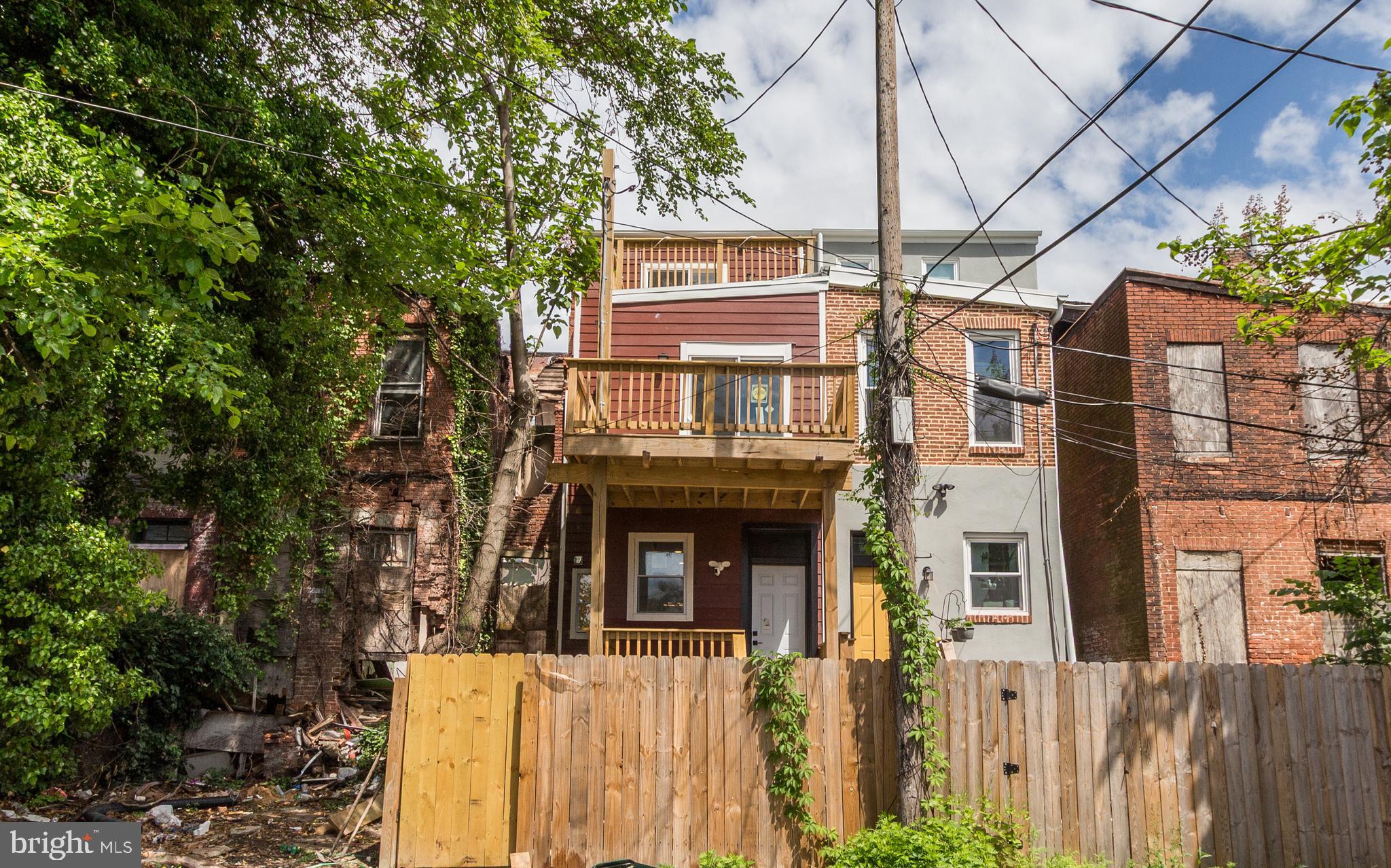 1324 Aisquith Street Baltimore, MD 21202 - Photo 44 of 47 a front view of a building with a tree