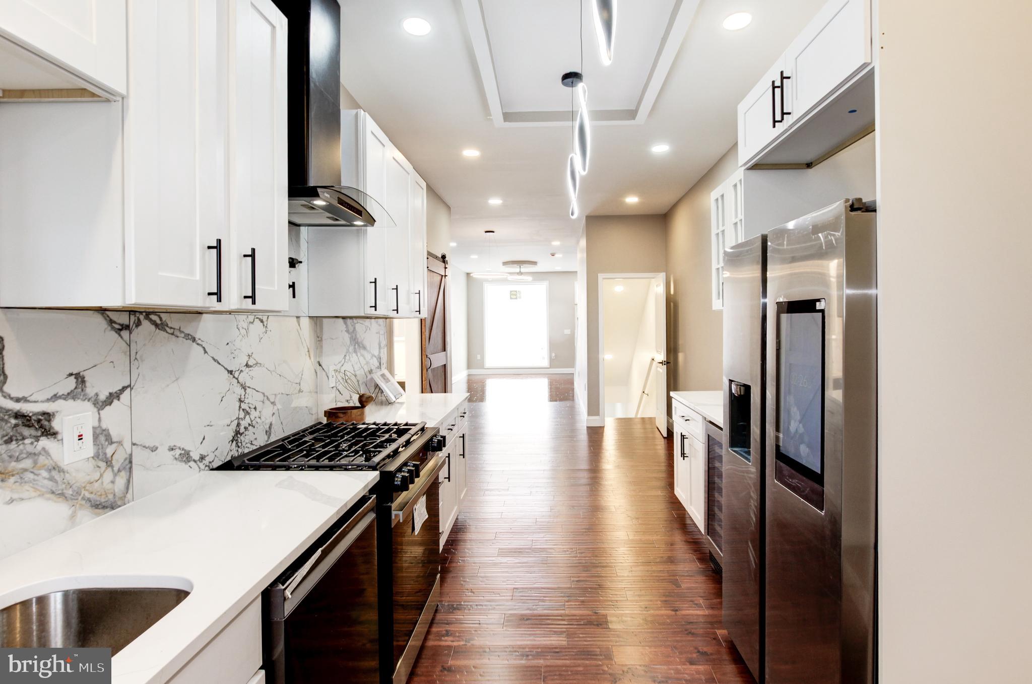 1324 Aisquith Street Baltimore, MD 21202 - Photo 5 of 47 a kitchen with kitchen island granite countertop lots of counter top space and stainless steel appliances