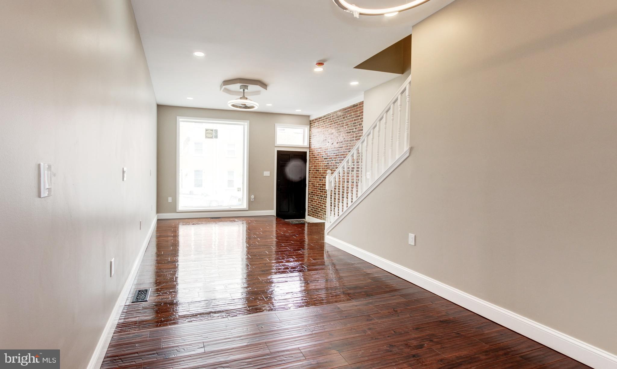 1324 Aisquith Street Baltimore, MD 21202 - Photo 10 of 47 a view of empty room with wooden floor and fan