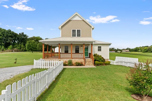 a front view of a house with garden and porch