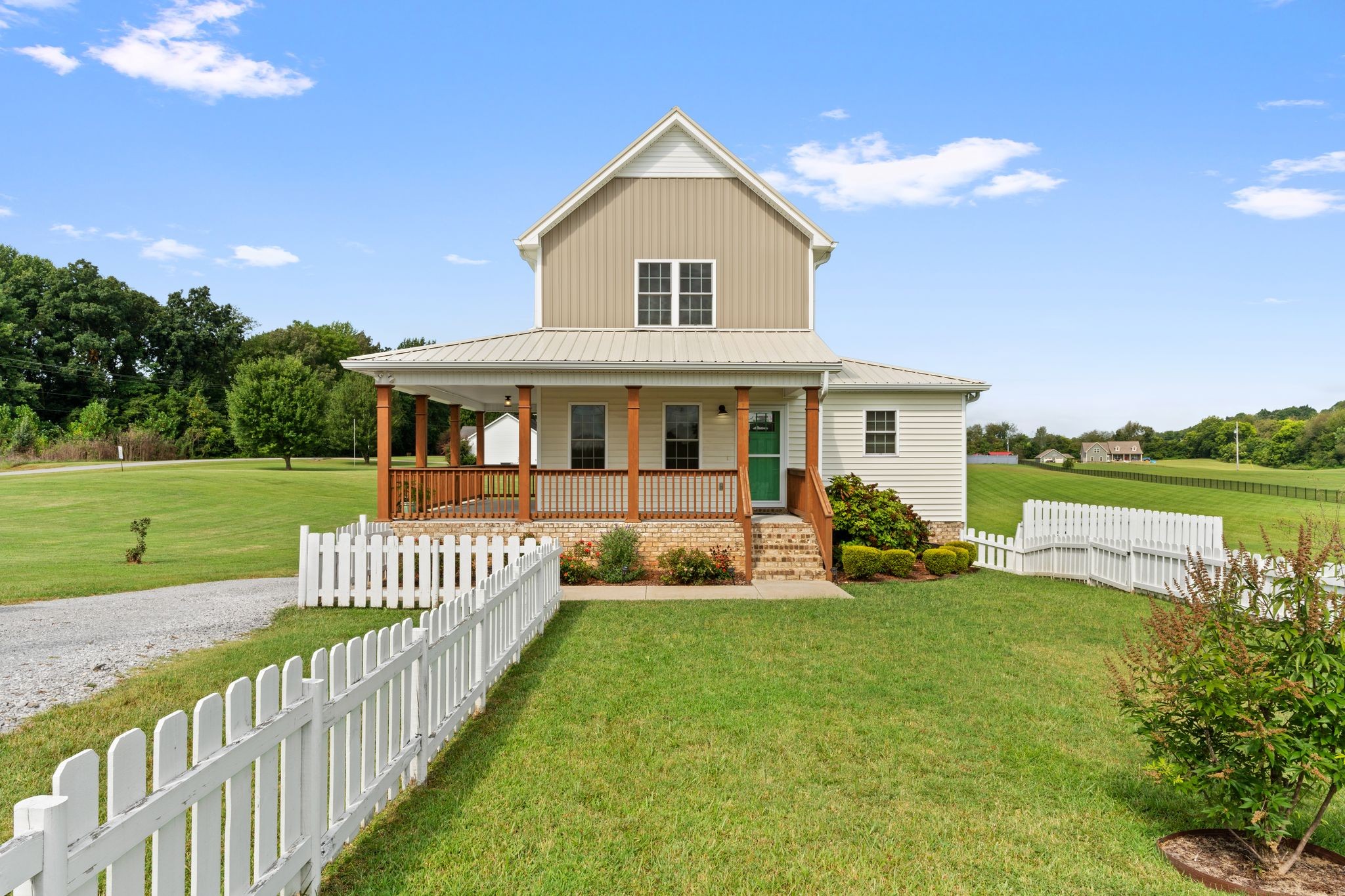 a front view of a house with garden and porch