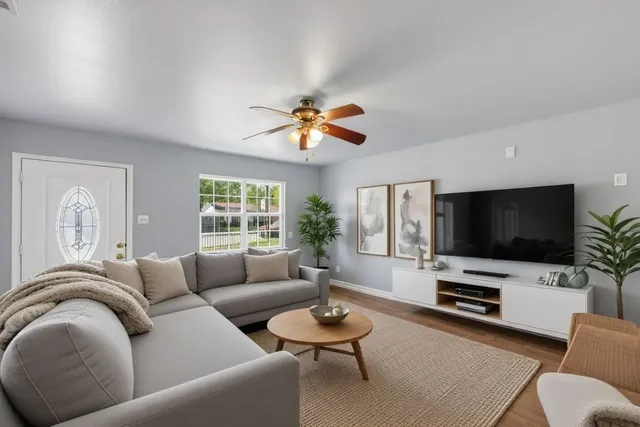 a living room with furniture and a flat screen tv