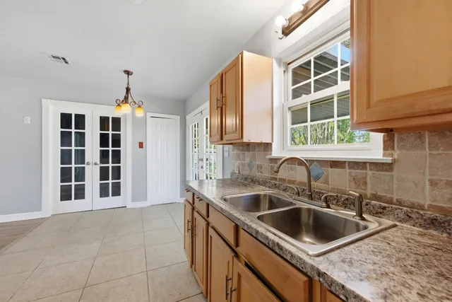 a kitchen with a sink and a refrigerator
