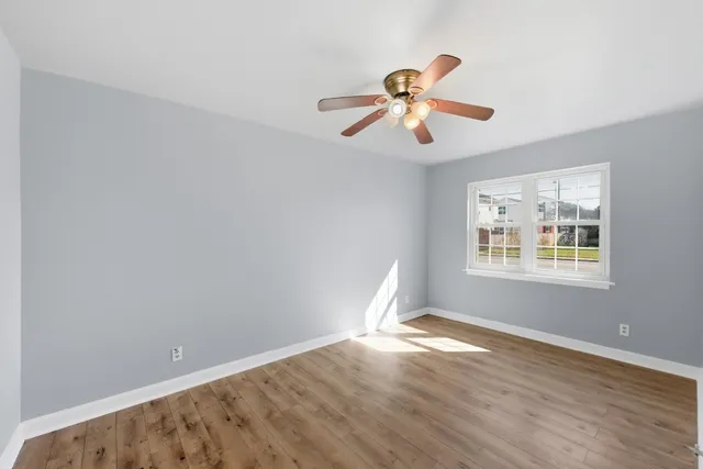 a view of a room with wooden floor and windows