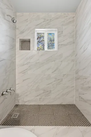 a view of a room with wooden floor and a ceiling fan
