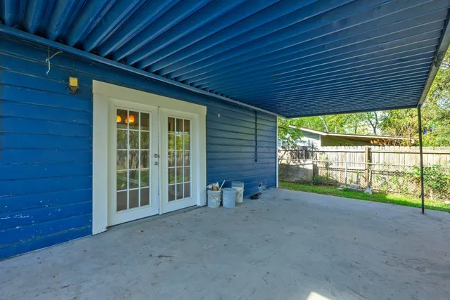 a view of a porch with furniture and floor to ceiling window