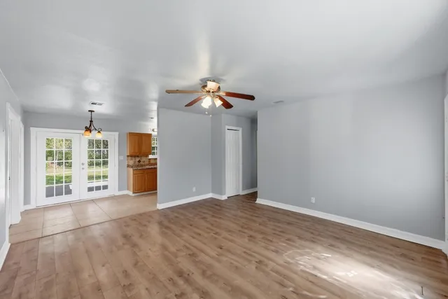 a view of a livingroom with wooden floor and window