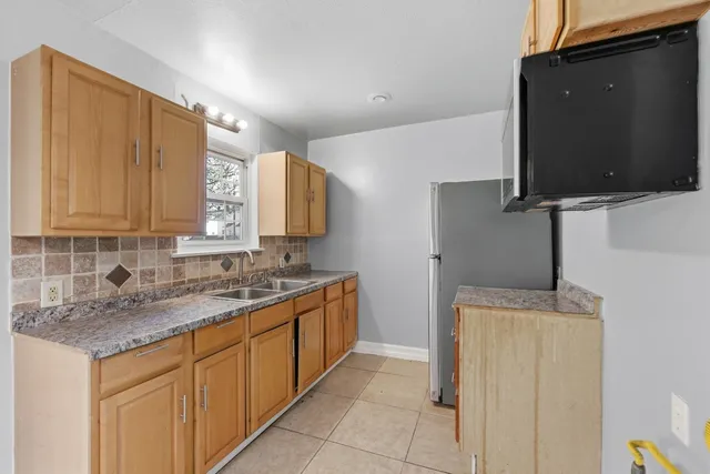a kitchen with stainless steel appliances granite countertop a sink stove and microwave