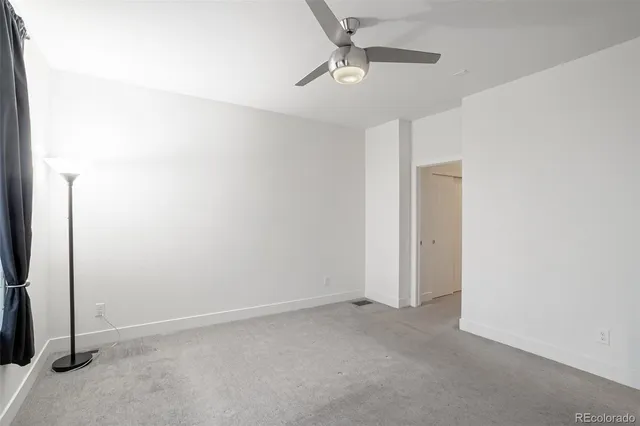 an empty room with a empty space and a ceiling fan
