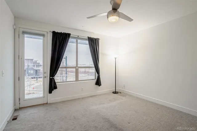 an empty room with windows and entrance