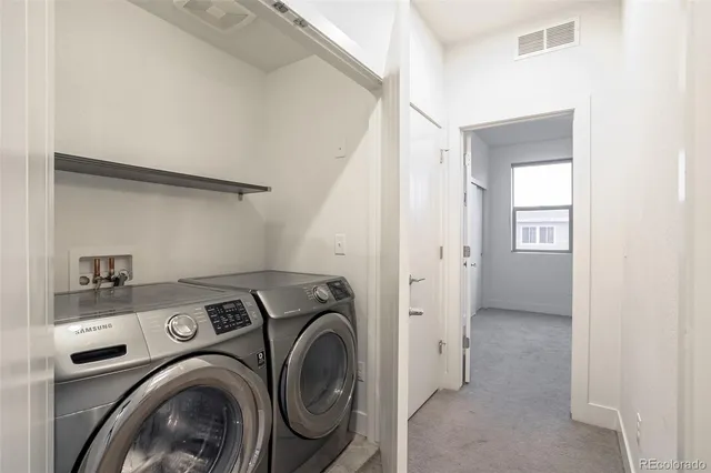 a view of storage and utility room with washer and dryer