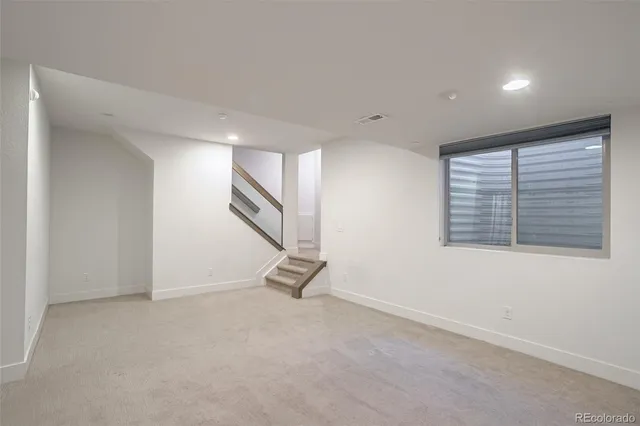 an empty room with a empty space and windows