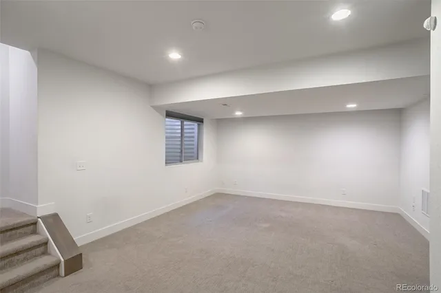 an empty room with a empty space and windows