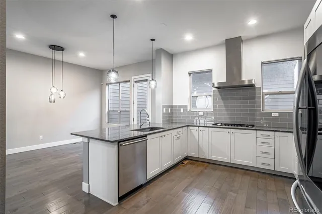 a kitchen with granite countertop a sink and cabinets