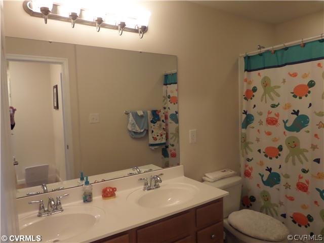 6107 Arbor Ridge Chester, VA 23831 - Photo 14 of 24 a bathroom with a sink vanity mirror and toilet