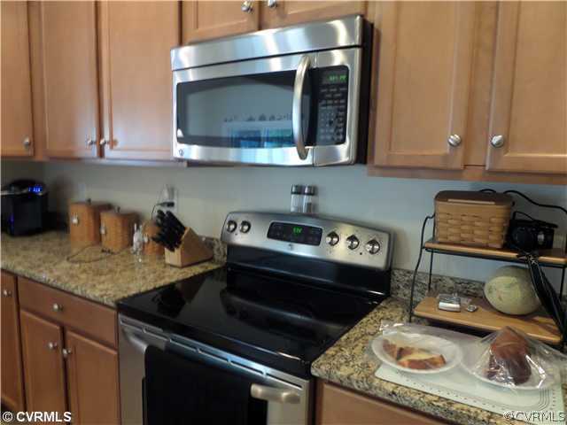 6107 Arbor Ridge Chester, VA 23831 - Photo 6 of 24 a kitchen with a stove and a microwave