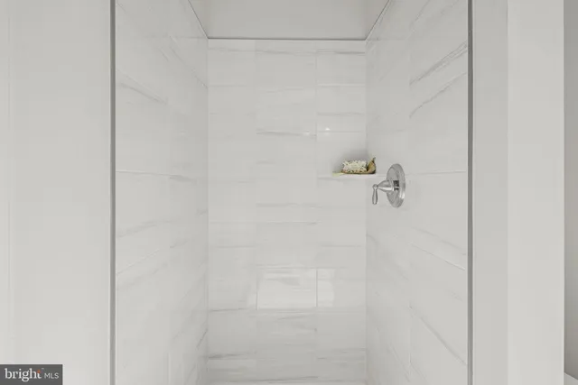 a view of a livingroom with a window and a ceiling fan