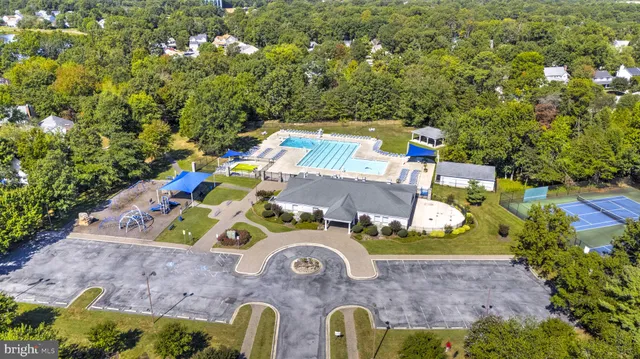 a view of a big house with a big yard and large tree