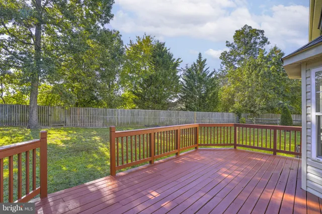 a view of balcony with wooden floor and fence