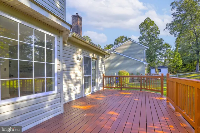 a view of a house with a big yard and large trees