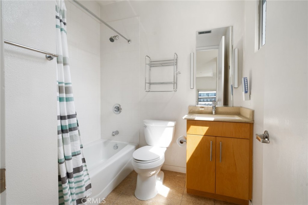133 The, Unit 404 Long Beach, CA 90802 - Photo 11 of 25 a bathroom with a toilet and a shower