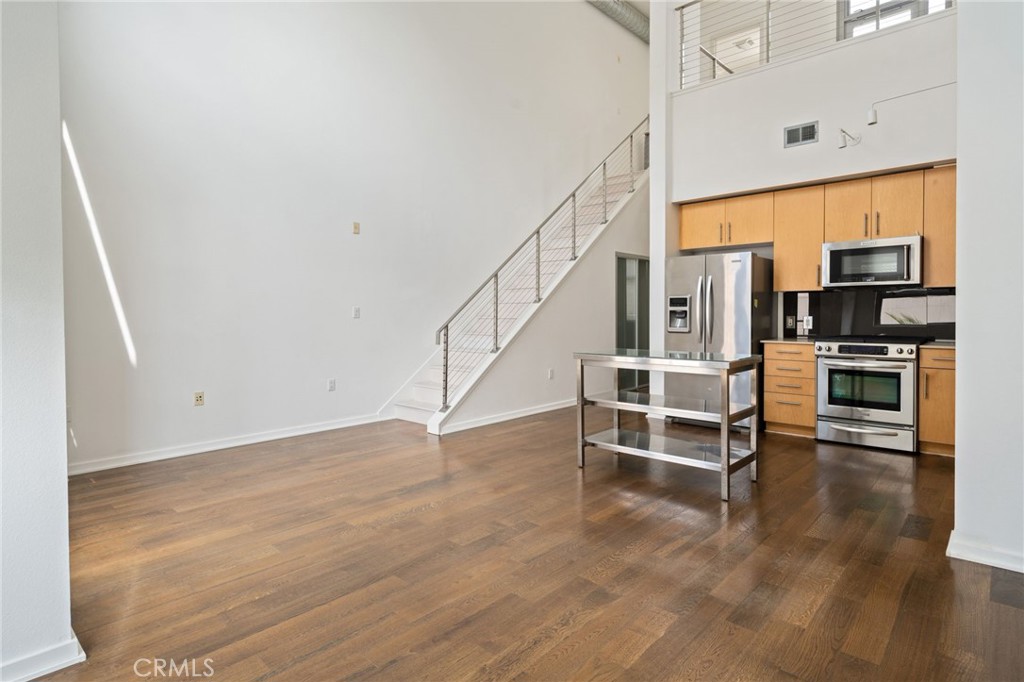 133 The, Unit 404 Long Beach, CA 90802 - Photo 8 of 25 a view of a kitchen with furniture and wooden floor
