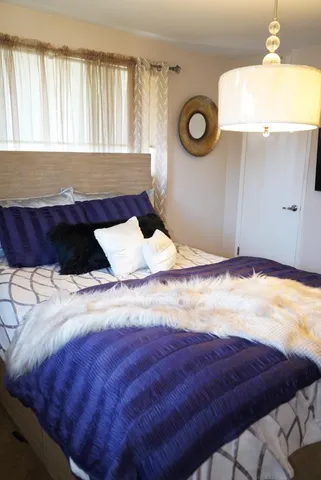 a bedroom with a bed and a window