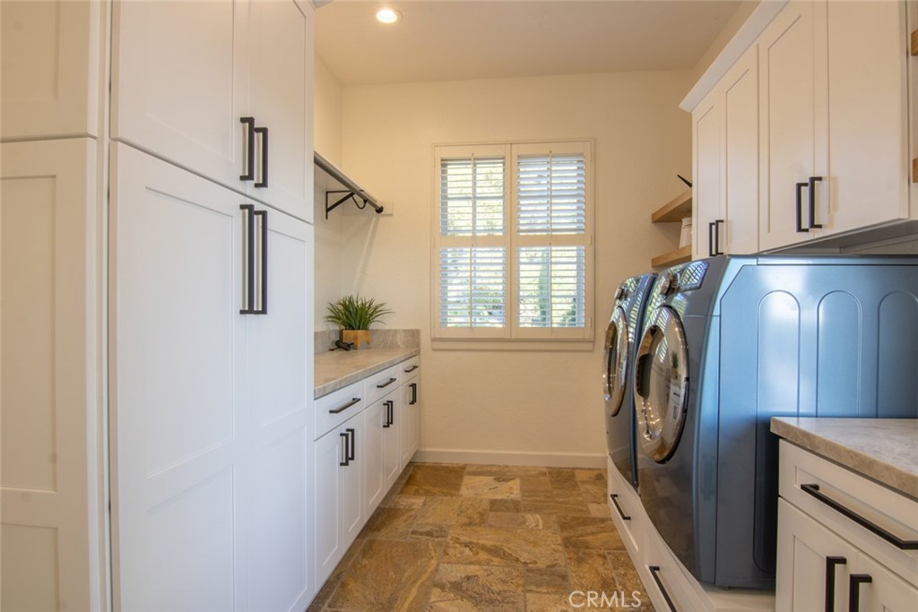 4567 Sleeping Indian Road Fallbrook, CA 92028 - Photo 18 of 72 a bathroom with a sink a washer and dryer