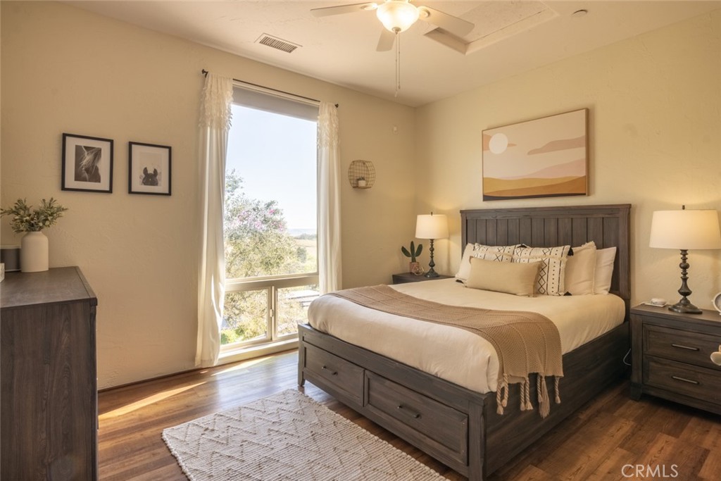 4567 Sleeping Indian Road Fallbrook, CA 92028 - Photo 20 of 72 a large bedroom with a bed wooden floor and window