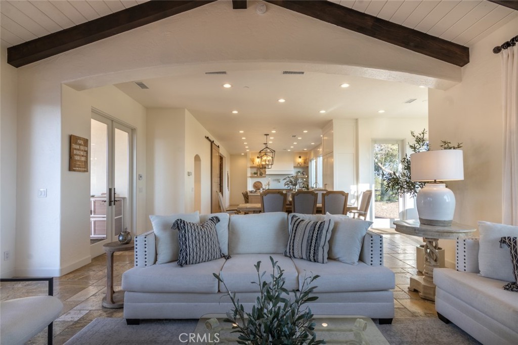 4567 Sleeping Indian Road Fallbrook, CA 92028 - Photo 48 of 72 a living room with furniture kitchen view and a chandelier