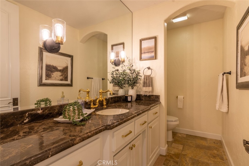 4567 Sleeping Indian Road Fallbrook, CA 92028 - Photo 69 of 72 a bathroom with a granite countertop sink and a mirror