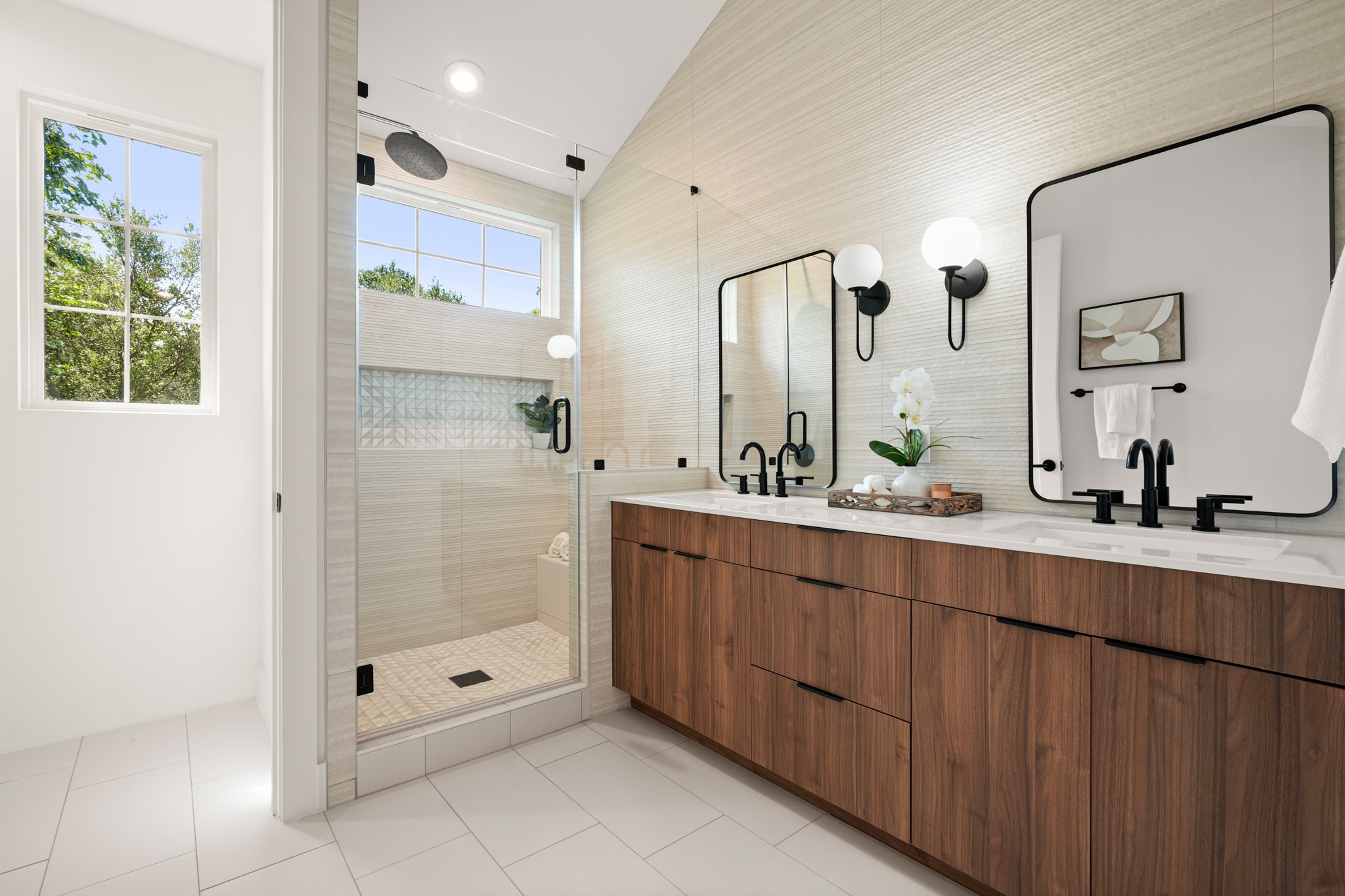 601 Vermont Road, Unit 2 Austin, TX 78702 - Photo 15 of 31 A well-appointed primary bathroom showcases a glass-enclosed shower and a dual-sink vanity with abundant storage.