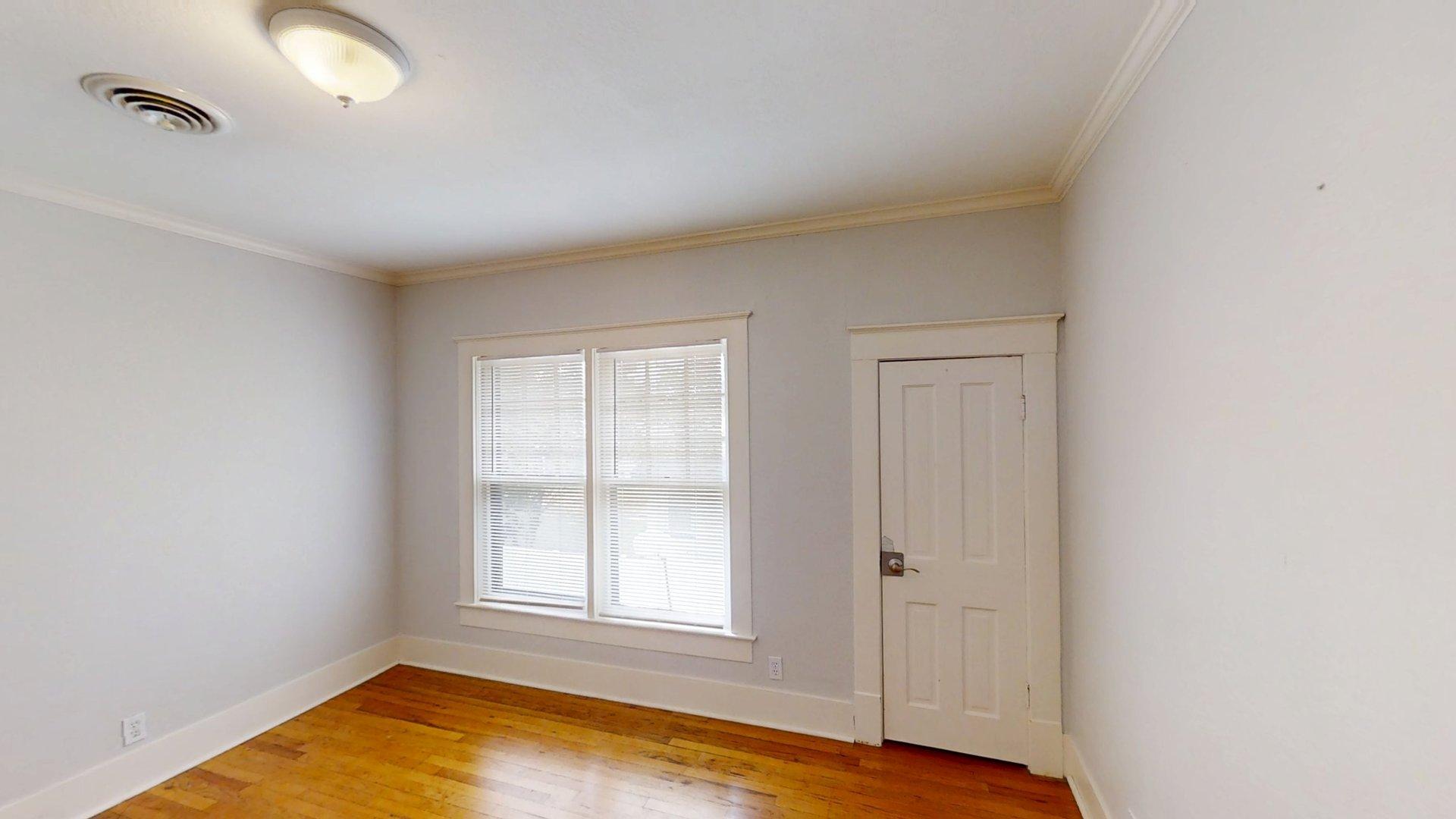 219 F Street Southwest Ardmore, OK 73401 - Photo 21 of 58 Warm wood-finish flooring, white trim, and crown molding