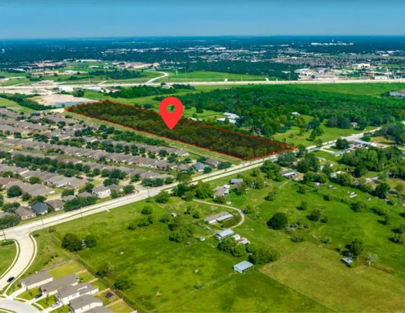 a view of a field with an ocean