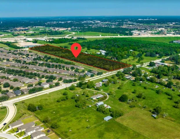 a view of a field with an ocean