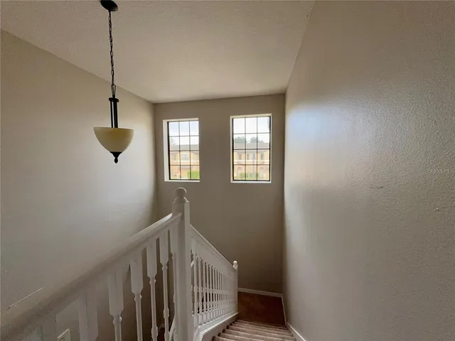a view of a hallway with closet and bathroom