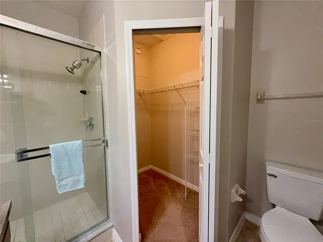 a bathroom with a granite countertop sink shower and mirror