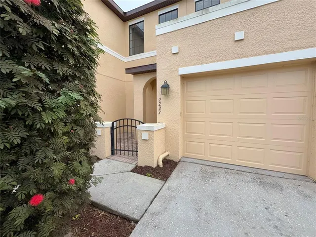 a view of a house with a flower garden